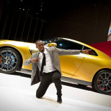 Usain Bolt gestures to fans at Nissan HQ.