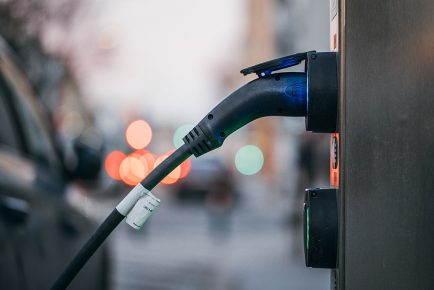 Close-up_of_an_electric_car_charging_station_with_a_car_plugged_in